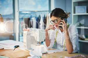Are you sure about these changes. an attractive young fashion designer making a phonecall while working in her design studio.