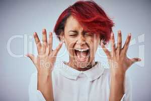 I need a manicure right now. Studio shot of an attractive young woman screaming against a gray background.