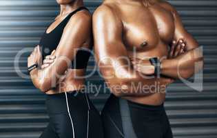 Why be ordinary when you can be legendary. Closeup shot of a sporty couple standing together against a grey background.