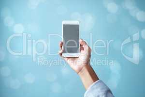 Female hand, isolated, holds phone with blank screen with copy space ready for your app or online internet search Close up of a businesswoman holding a smartphone against a blurred blue background