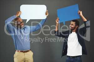 Men holding speech bubbles for social media communication via messaging, chatting and texting. Team of happy, smiling and excited marketing professionals showing networking through online platforms
