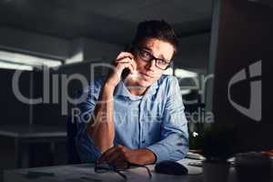 Stressed, overworked and worried while talking on phone to solve problem while working late night at the office. Serious and exhausted man calling IT about computer issue trying to reach deadline