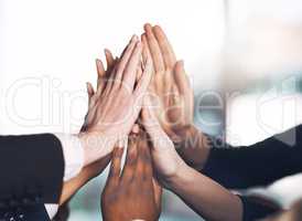 Business people giving high five for motivation, unity, and support in a meeting together at work. Closeup of hands of colleagues and employees huddling to celebrate a success, victory or win