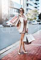 Fashion, fun and shopping in a city with trendy young woman enjoying retail therapy. Happy female enjoying carefree shopping spree and satisfaction of a sale downtown. Excited lady spoiling herself