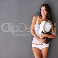 Copy space for a health gym, diet and fitness advert with beautiful woman holding a scale in underwear. Confident female showing her feminine shape, motivation for weight loss and a healthy lifestyle