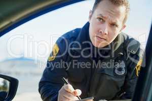 Im afraid Im gonna have to write you up. a handsome young male traffic officer issuing a ticket at a roadblock.