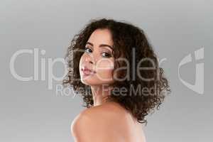 The perfect skin takes time and effort. Studio shot of a beautiful young woman posing against a gray background.