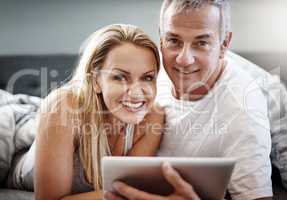 Well get up after this episode. a mature couple using a digital tablet while lying in bed.