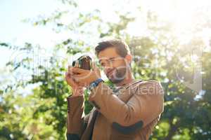 Photography is his passion. a handsome young man taking photographs during his morning commute.