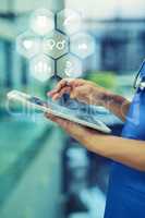 All the information she needs is right at her fingertips. an unrecognizable female nurse using a tablet while standing in the hospital.