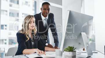 Considering every piece of significant info before making decisions. two businesspeople working together in an office.