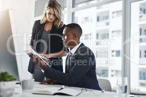 They manage all their business operations together. two businesspeople working together in an office.