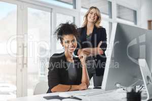 Dedication has taken us both right to the top. Portrait of two businesswomen working together in an office.
