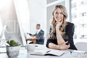 Time to get productive. Portrait of a young businesswoman working at her desk in a modern office.