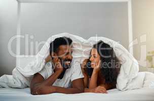 Waking up to you is a blessing. a young attractive couple in bed at home.