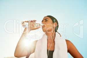 Its fuel for a better workout. a sporty young woman taking a break while exercising outdoors.