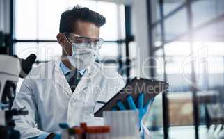 Looking at new ways to improve the health of humanity. a young male scientist working in a lab.