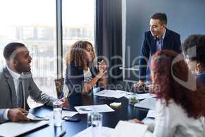 Making her valuable contribution to the team. a group of businesspeople having a meeting in the boardroom.