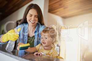 Simple chores can help them learn responsibility from an early age. a mother and her little daughter doing chores together at home.