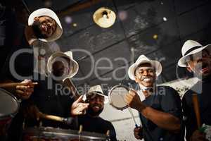 Its carnival time. Portrait of a group of musical performers playing drums together.