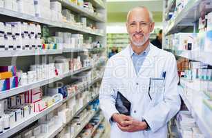 What seems to be ailing you. Portrait of a confident mature pharmacist working in a pharmacy.