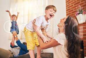 Family, the most important ingredient for a happy home. Portrait of a happy young family enjoying playtime together at home.