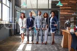 You can just sense how determined they are. Portrait of a group of businesspeople standing together in an office.