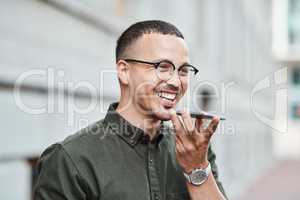 Young, professional and happy businessman using a phone outdoors. Positive male smiling while speaking on a call. Handsome guy standing alone outside while using technology to communicate with family