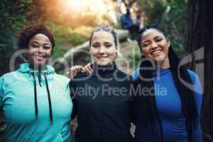 Bonding and getting better. Portrait of sporty young women working out in the forest.