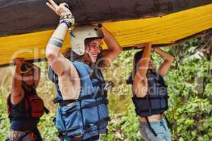 All good things are free and wild. a group of friends on their way to the river with a raft.