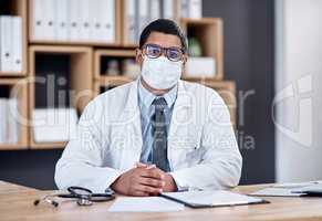 Doctor wearing covid mask in clinic to prevent spread of pandemic virus, disease or illness in hospital consult. Portrait of medical professional, healthcare oe frontline worker ready to treat people