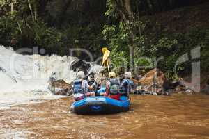 Life has no limitation, except the ones you make. a group of friends out river rafting on a sunny day.