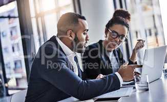 Theyve got the expertise to go big. two businesspeople working together on a laptop in an office.