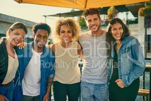 Rooftop celebrations with the best people. Portrait of a group of young diverse friends spending the day outside on a rooftop.