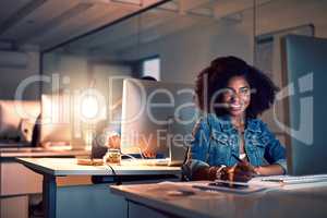 Working hard to raise my position in my career. Portrait of a young businesswoman working late on a computer in an office.