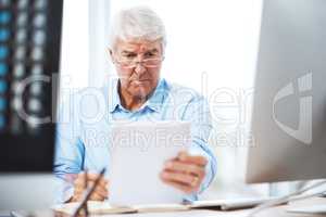 Hard work is never finished. a handsome senior businessman working on a tablet at home.