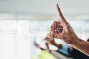 Raising hand and finger to ask a business question in a modern office. Closeup of group of colleagues with raised fingers at a conference meeting or seminar with bright ideas over copy space.