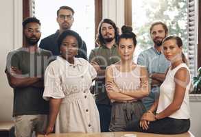 Serious business people standing with arms crossed, looking confident and showing teamwork in an office together at work. Portrait of diverse creative employees expressing power, unity and success