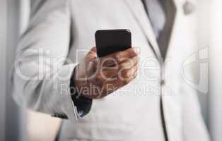 You need an instant connection to stay on top of things. Closeup shot of an unrecognizable businessman using a cellphone.