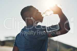 Dont become dehydrated, make sure you stay hydrated. a handsome young male runner taking a break and drinking water outdoors.