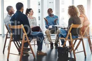 Business people in an informal meeting, team building discussion or group project planning session. Leader, manager or supervisor talking to diverse colleagues or employees about workflow management