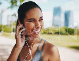 Shes found just the perfect soundtrack. an attractive young sportswoman listening to music while working out outdoors in the city.