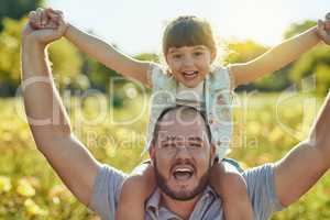 When youre winning at parenthood. an adorable little girl and her father playing together in the park.