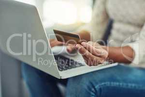 The most comfortable place to make payments. an unrecognizable woman making payments online with a credit card at home.