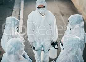 Covid pandemic outbreak team of doctors or medical workers wearing protective ppe to prevent spread of virus outside. Group of scientists wearing hazmat suit for corona or ebola disease in the street