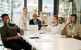 Smiling, diverse and creative marketing team sitting in a boardroom meeting for startup business or company. New happy young people getting coaching from mature entrepreneur leaders using a laptop