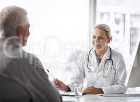You seem in perfect health to me. a mature female doctor working with a senior male patient in her office in the hospital.