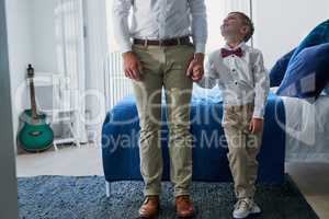 He wants to be just like his dad when he grows up. an adorable little boy and his unrecognizable father dressed in matching outfits.