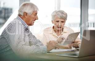 Making sure theyre set for retirement. a senior couple working on their finances at home.