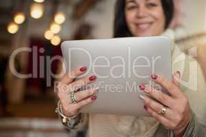 Managing her store online. Closeup shot of a digital tablet in the hands of a female boutique owner.